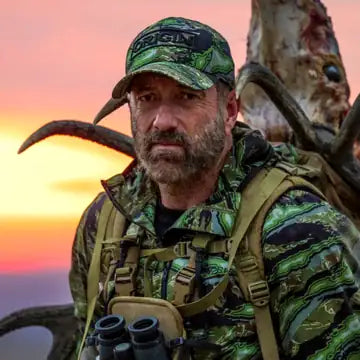 Cameron Hanes in camouflage hunting gear at sunset