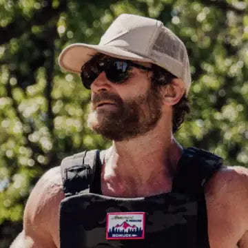 Eric Hinman running outdoors in a weight vest